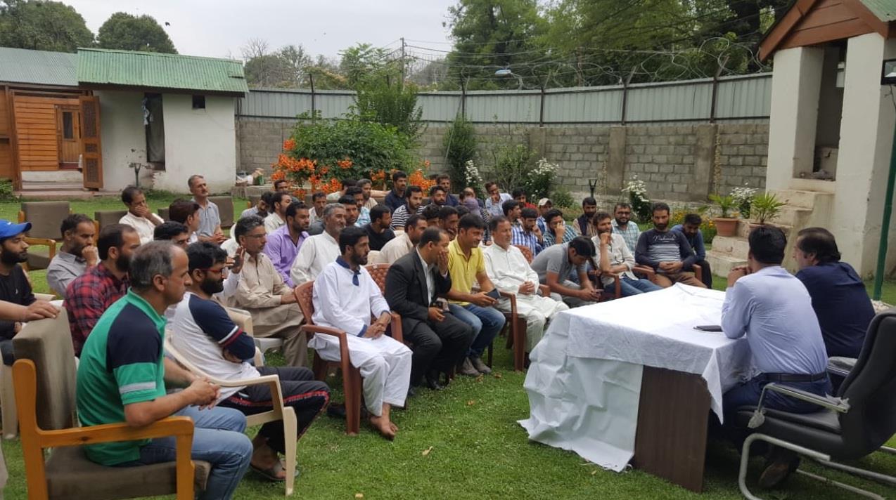Sajad Lone interacts with political workers from Tangmarg